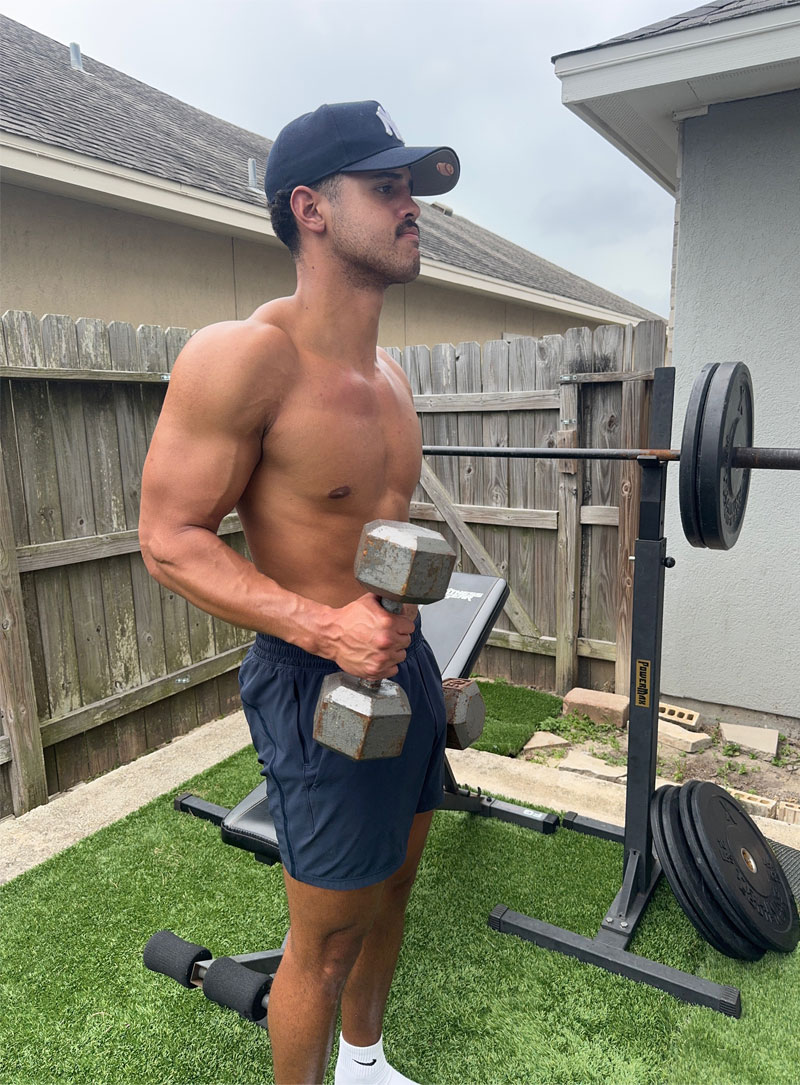 Coach outside lifting weights